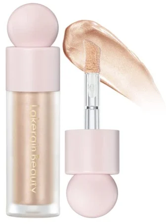 A bottle of Erinde Liquid Highlighter with a soft pink cap and wand applicator showcasing its shimmering texture in the background.