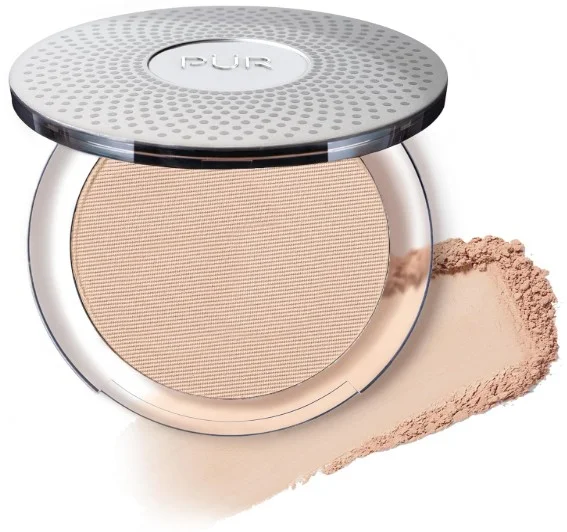 A compact of PÜR Beauty 4 in 1 Pressed Mineral Makeup with SPF 15 featuring foundation, concealer, and finishing powder, shown with some of the powder beside it.